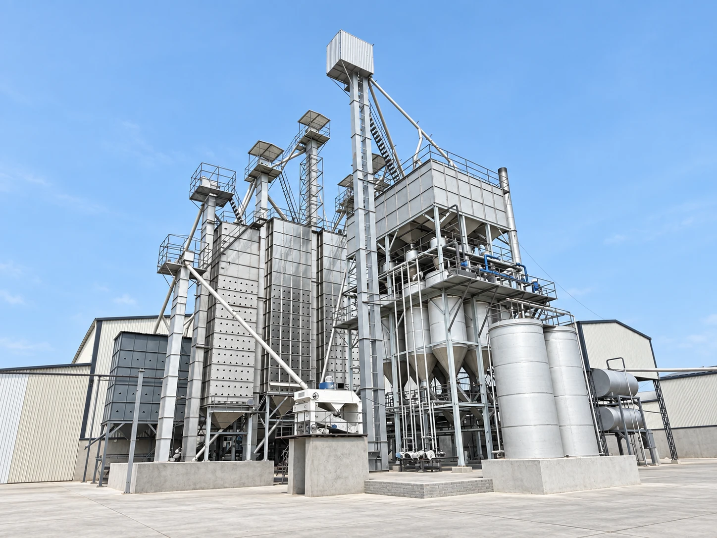 Exterior view of the paddy-processing plant, showing the full installation and adjoining buildings